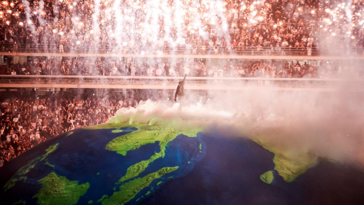Pyrotechnics above Kanye West on the globe stage