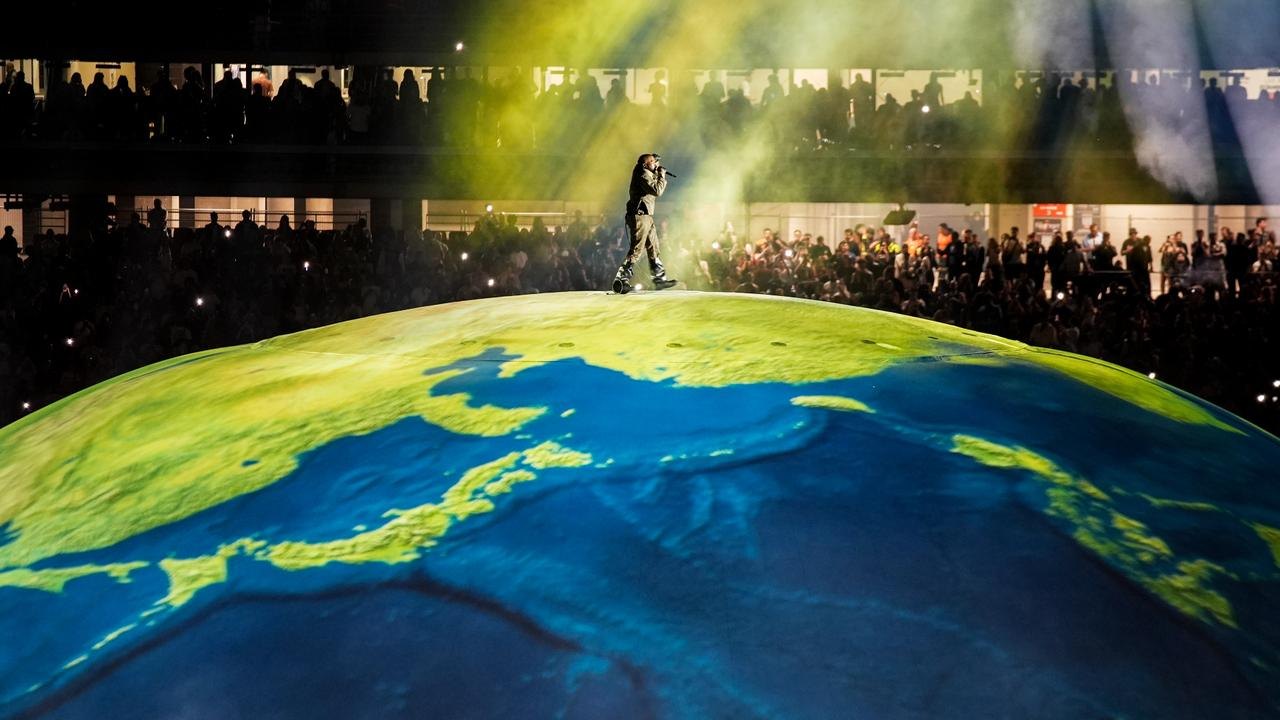 Kanye West performing on the globe stage